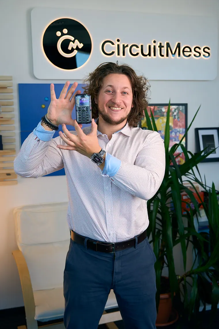 Full-length, standing with MAKERphone 2.0 under the CircuitMess logo