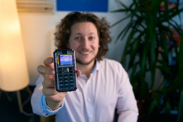 MAKERphone 2.0 held out at arm's length, screen towards the lens